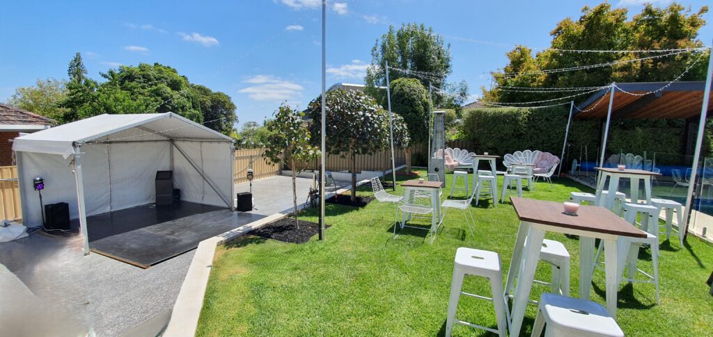 Party Hire Adelaide - Elegant outdoor party setup in Adelaide featuring a white canopy stage, bar stools, and high tables—available from Australian Hiring Company.