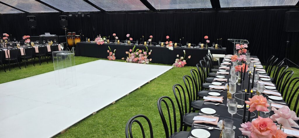 Elegant marquee wedding setup at SA Museum featuring white dance floor, Harper bar station, black frame marquee, ambient lighting, and designer furniture by Australian Hiring Company.