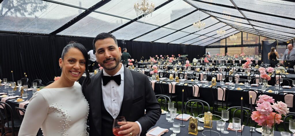 Marquee hire Adelaide - Elegant black frame marquee setup for C&JP’s wedding at the SA Museum, featuring curated lighting, furniture, and dance floor by Australian Hiring Company.