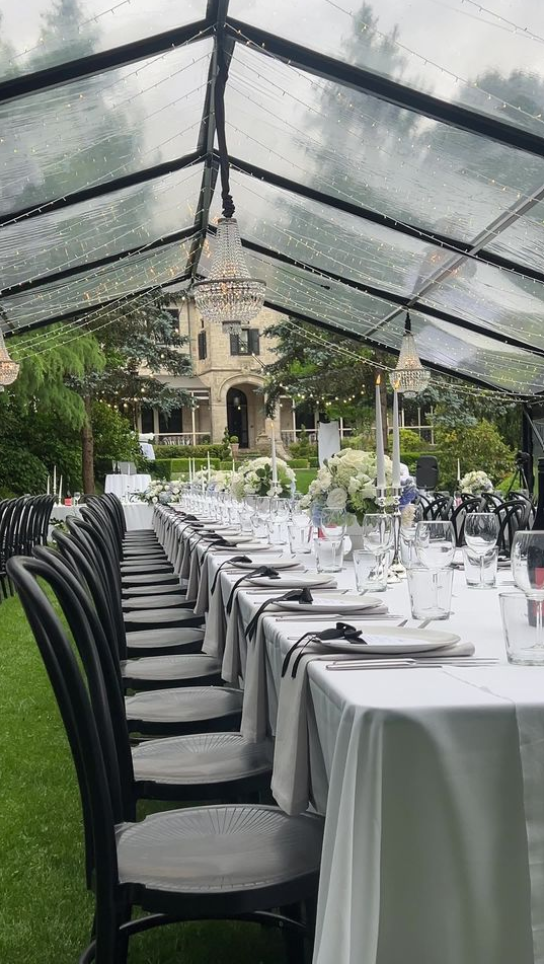 Luxury black marquee wedding setup at Eurilla Estate with timber dance floor, designer furniture, and ambient lighting.