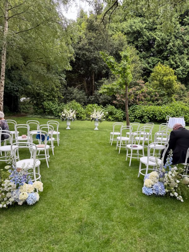 Black marquee wedding reception on the bowling green at Eurilla Estate with designer furniture, timber dance floor, and ambient lighting.
