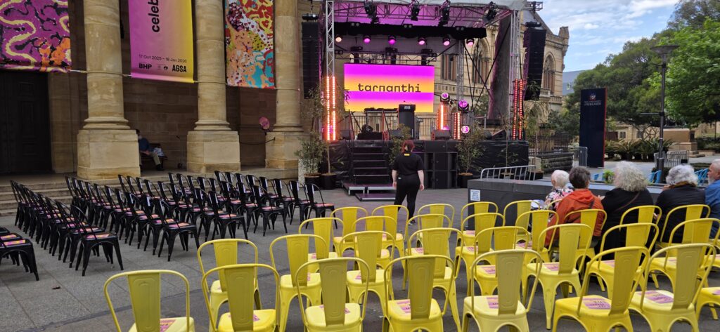 Early event setup for Tarnanthi 2025 at AGSA on North Terrace, featuring Tolix chairs, stage cover, and event infrastructure supplied by Australian Hiring Company.