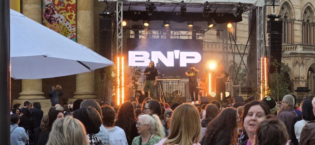 Live BN’P performance at Tarnanthi 2025 outside AGSA, featuring stage cover, lighting, and event infrastructure supplied by Australian Hiring Company.